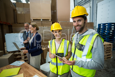 Warehouse workers standing together in warehouse