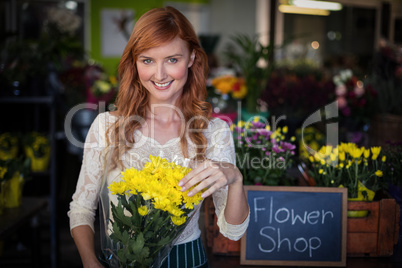 Female florist holding flower bouquet