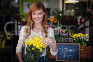 Female florist holding flower bouquet