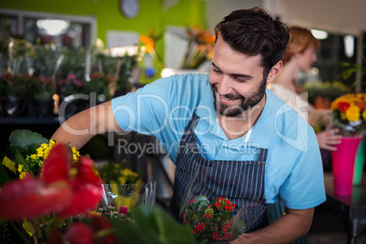 Male florist arranging flower bouquet