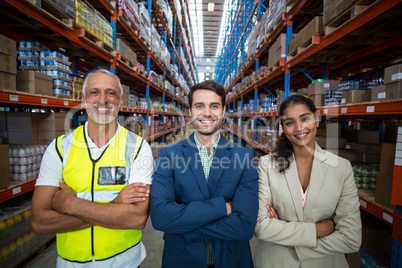 Portrait of warehouse team standing with arms crossed