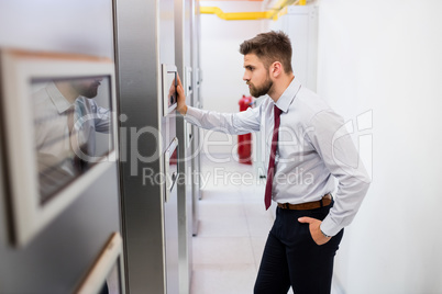 Technician looking at server cabinet
