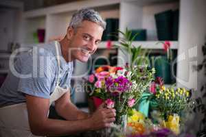 Happy florist preparing a flower bouquet