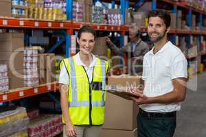 Male and female worker smiling while working