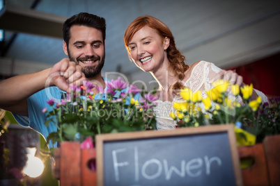 Couple preparing flower bouquet