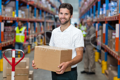 Male worker holding cardboard box