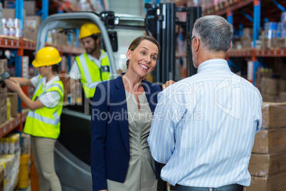 Warehouse manager and client interacting with each other