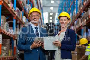 Warehouse manager and client smiling