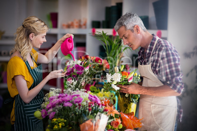 Female florist watering flowers