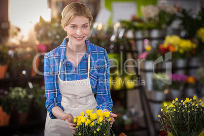 Female florist touching flower bouquet