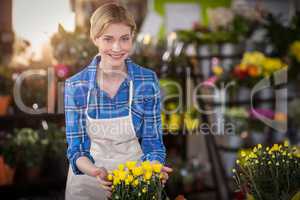 Female florist touching flower bouquet