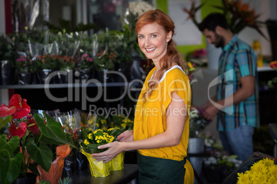 Female florist holding bouquet of flower