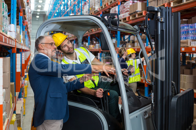 Warehouse manager interacting with male worker