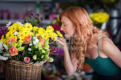 Female florist smelling flower