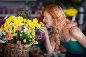 Female florist smelling flower