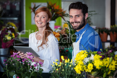 Couple standing with digital tablet