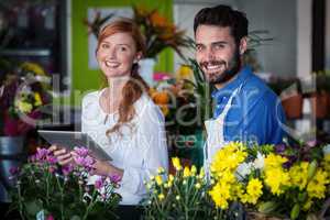 Couple standing with digital tablet