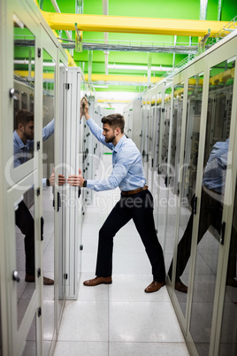 Technician adjusting server cabinet