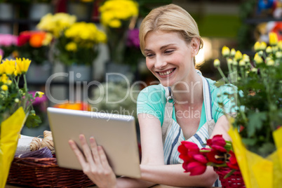 Female florist using digital tablet in florist shop