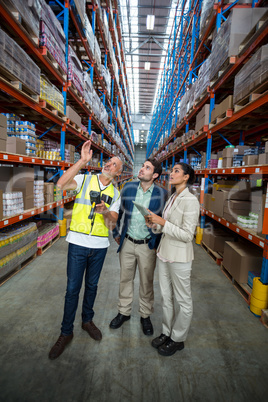 Warehouse team discussing with digital tablet