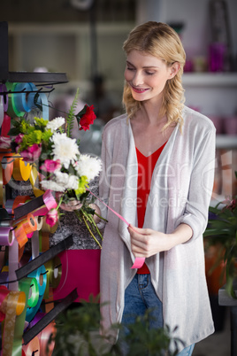 Female florist preparing a flower bouquet