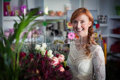 Female florist standing and smiling