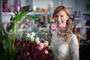 Female florist standing and smiling