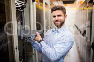 Technician removing server from rack mounted server