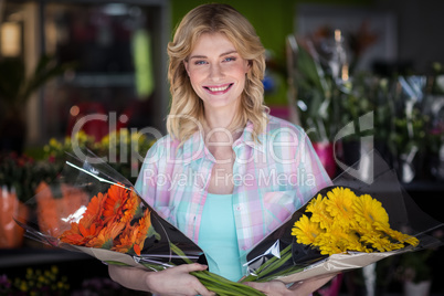 Happy female florist holding flower bouquet