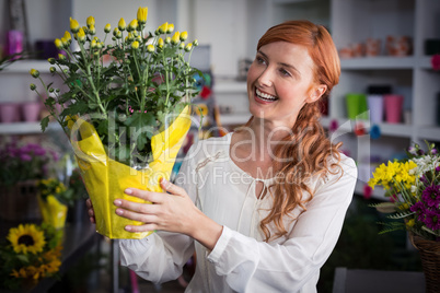 Female florist holding flower bouquet