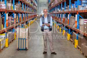 Warehouse manager holding digital tablet