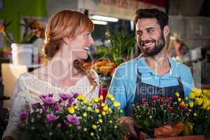 Couple holding crate of flower bouquet