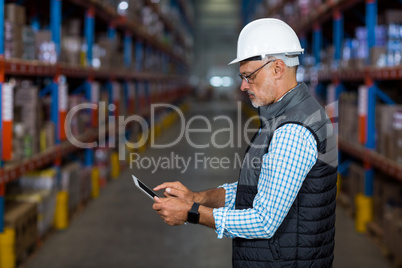 Warehouse worker using digital tablet