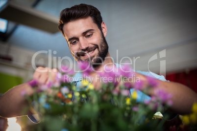 Male florist preparing flower bouquet