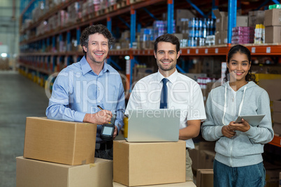 Portrait of warehouse manager and worker standing together