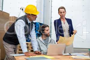 Warehouse workers and managers interacting with each other