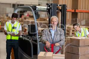 Warehouse manager and workers preparing a shipment