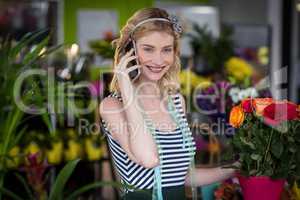 Female florist talking on mobile phone