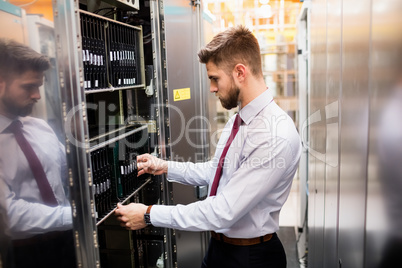 Technician examining server