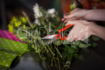 Hand of female florist preparing flower bouquet