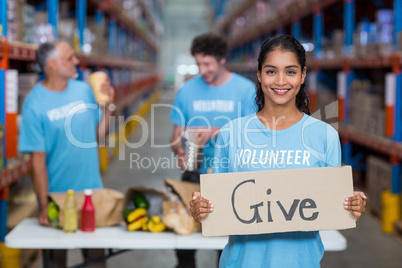 Portrait of happy volunteer holding sign boards with message