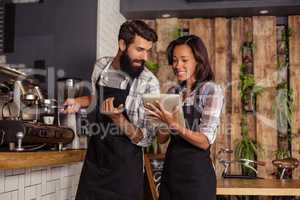 Waiter and waitresses using laptop while working