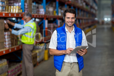 Warehouse worker holding digital tablet