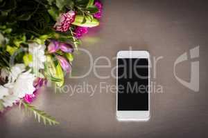Flowers and mobile phone on the table