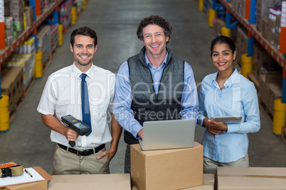 Portrait of warehouse manager and worker standing together