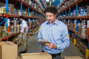 Warehouse worker using digital tablet