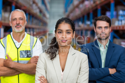 Portrait of warehouse team standing with arms crossed