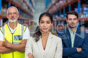 Portrait of warehouse team standing with arms crossed