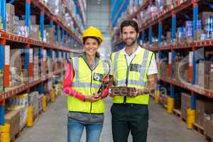 Male and female worker standing together