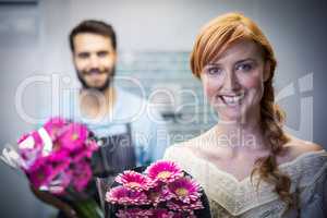 Portrait of couple holding flower bouquet